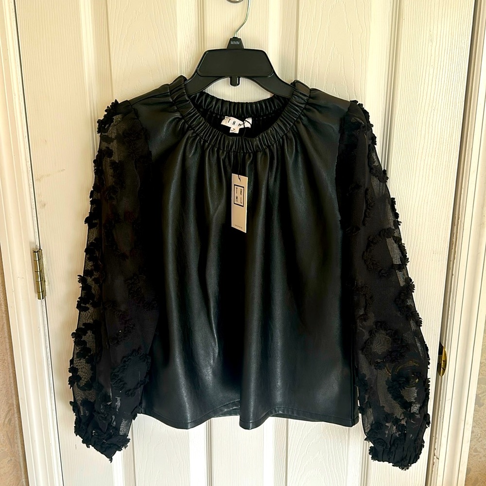 Black leather top with lace sleeves.  Elegant yet fun and chick